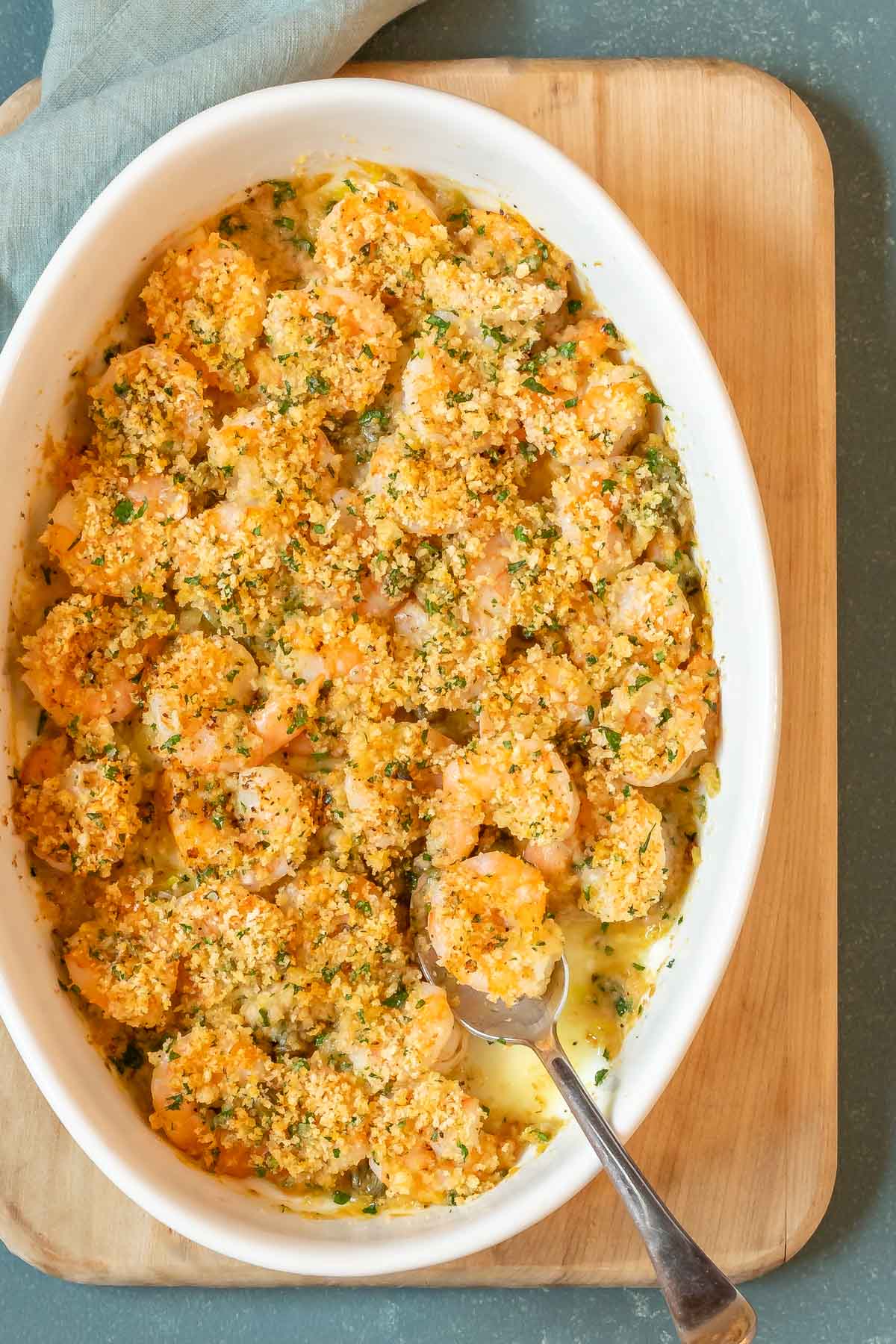 overhead shot of Baked Shrimp with a spoon holding one shrimp