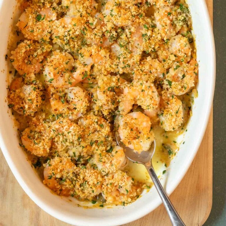 overhead shot of Baked Shrimp with a spoon holding one shrimp