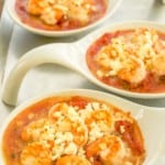 3 white small baking dishes holding Baked Shrimp with Tomatoes and Feta.