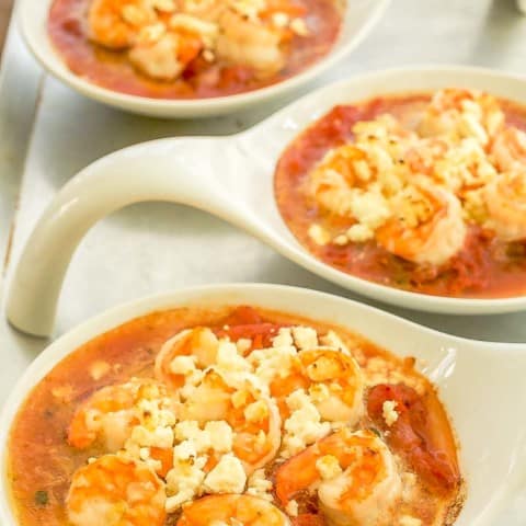 3 white small baking dishes holding Baked Shrimp with Tomatoes and Feta.