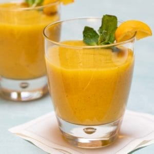 Clear glasses filled with Banana Mango Smoothies