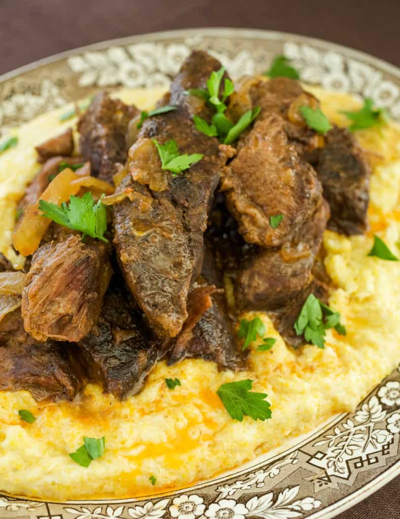 Cooked Beef Short Ribs sitting atop Creamy Parmesan Polenta