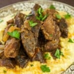 Cooked Beef Short Ribs sitting atop Creamy Parmesan Polenta.