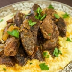 Cooked Beef Short Ribs sitting atop Creamy Parmesan Polenta