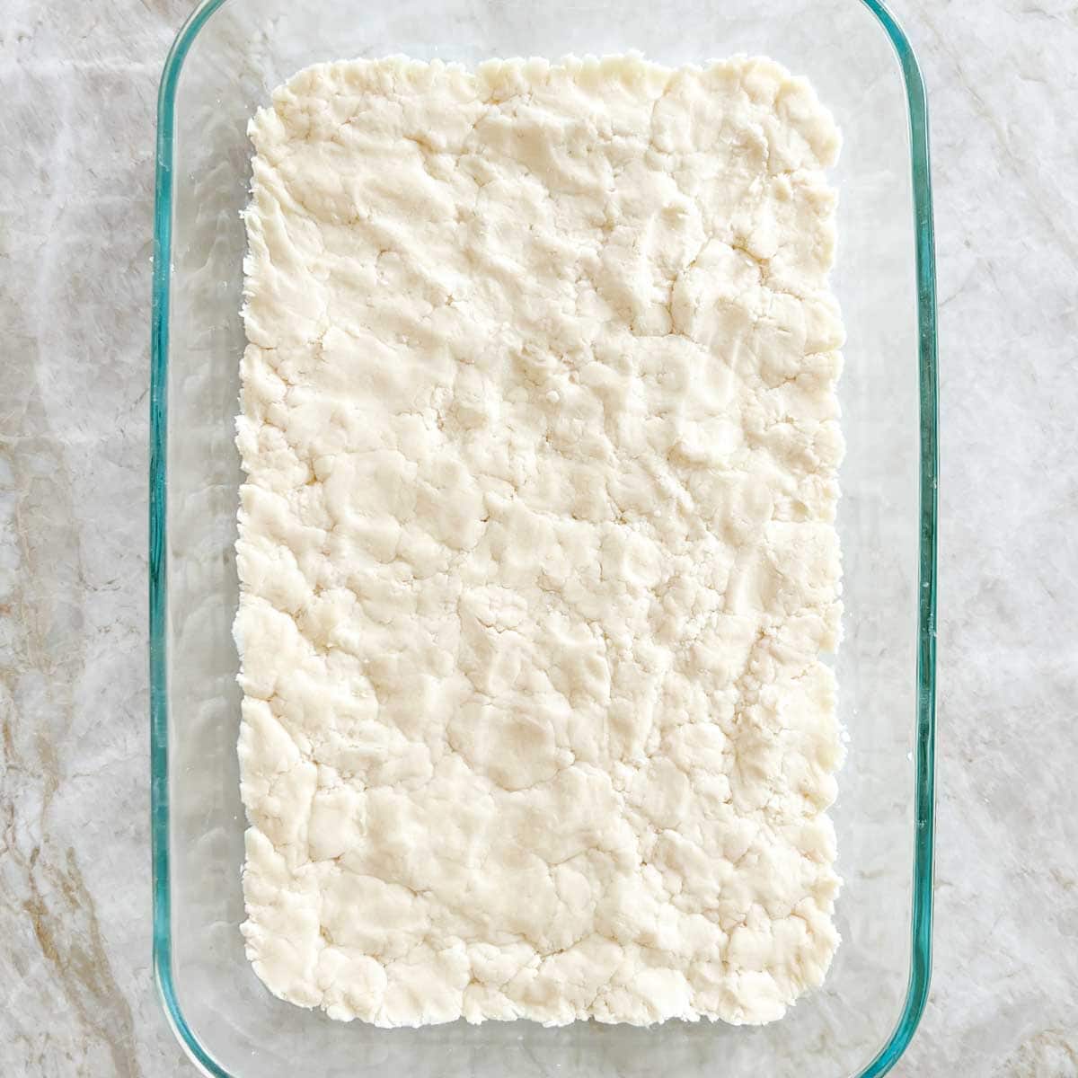 Crust dough pressed into baking dish, before baking