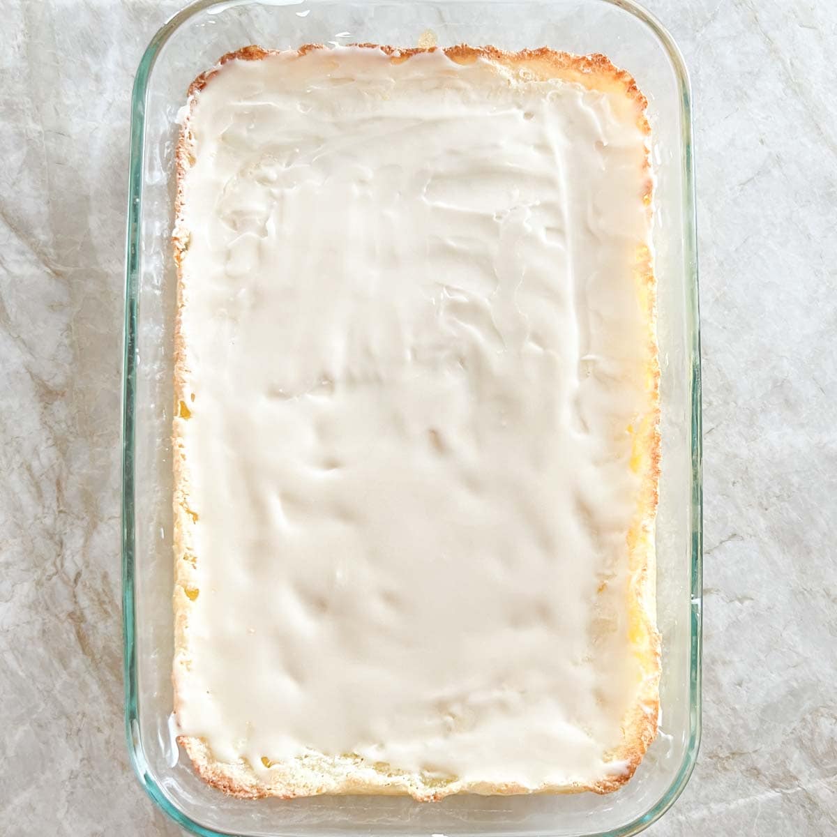 Frosted homemade lemon bars, in baking dish