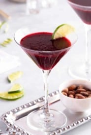 close up of a stemmed glass holding a Lime Blackberry Martini