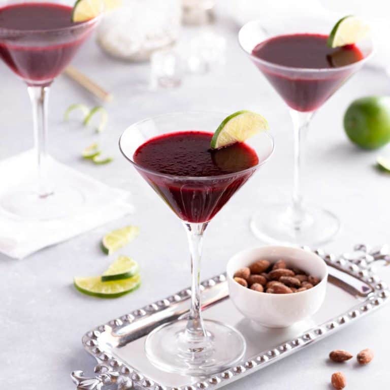 3 stemmed glasses holding Lime Blackberry Martinis