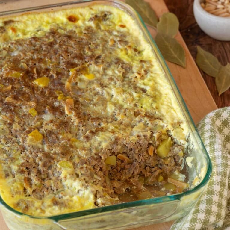 Close up of Bobotie with a corner removed, showing the inside