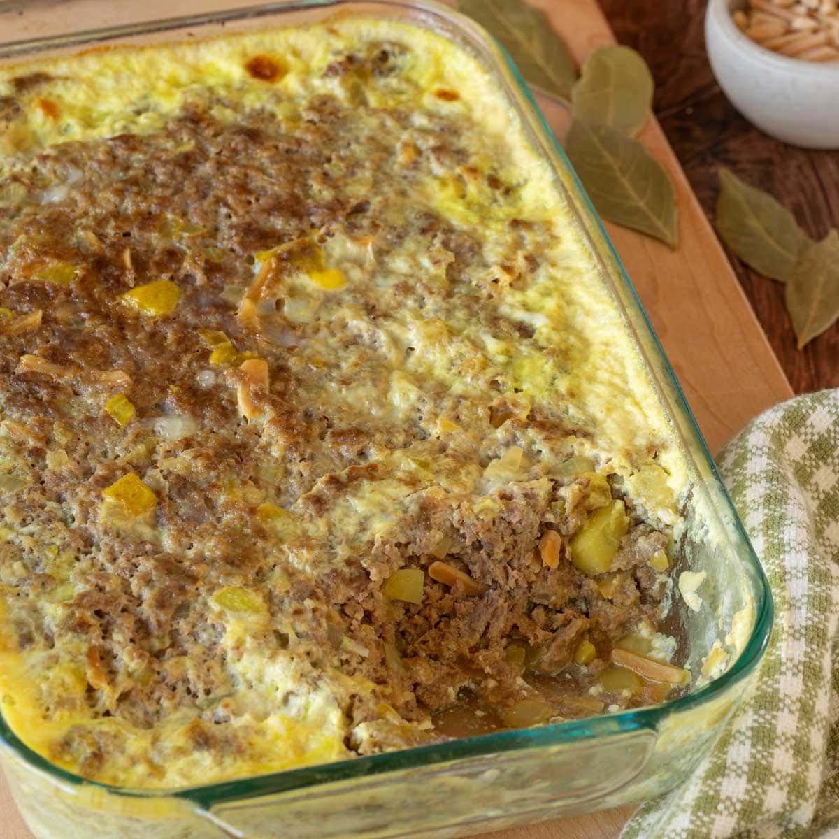 Close up of Bobotie with a corner removed, showing the inside