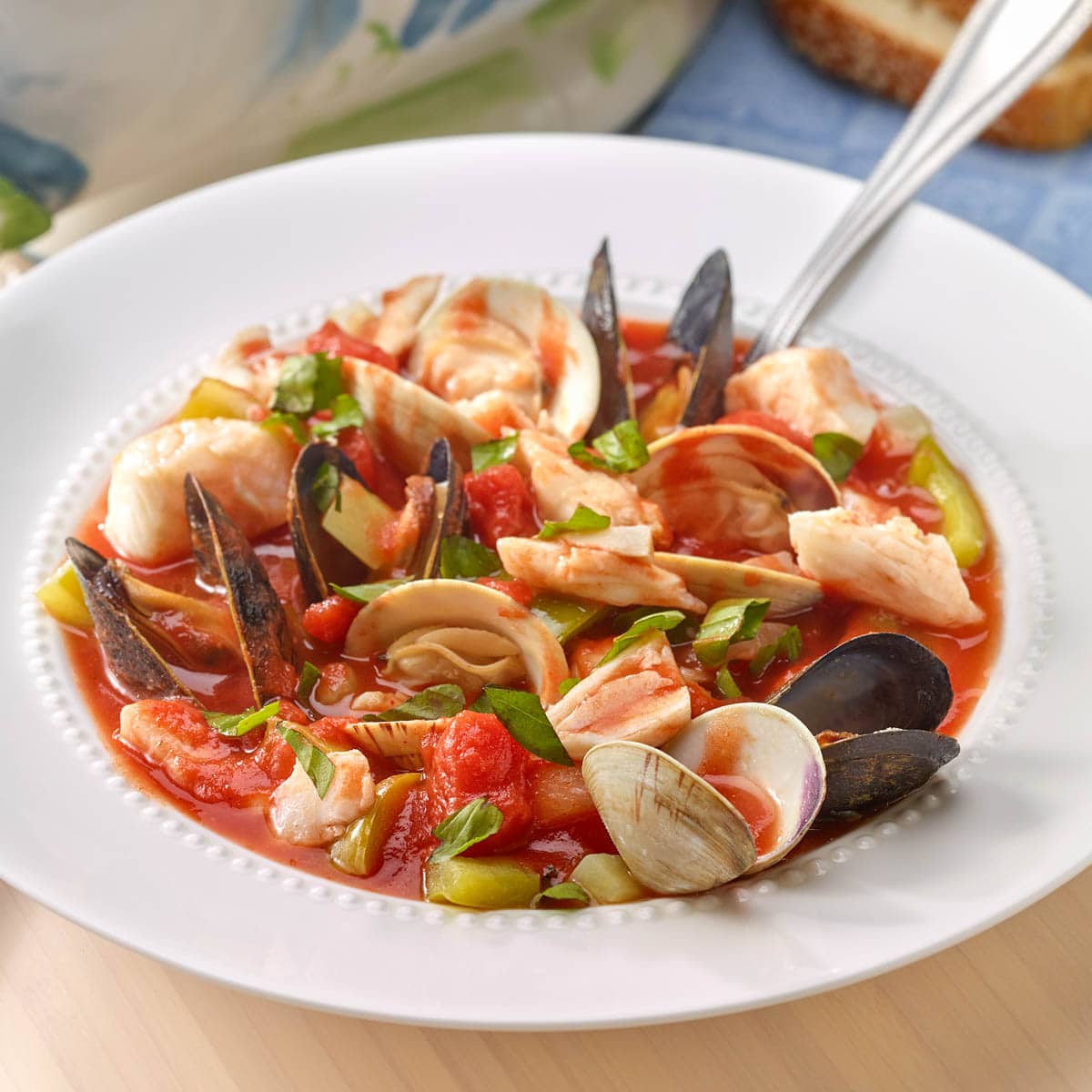 Close up of a white bowl holding a portion of Bouillabaisse