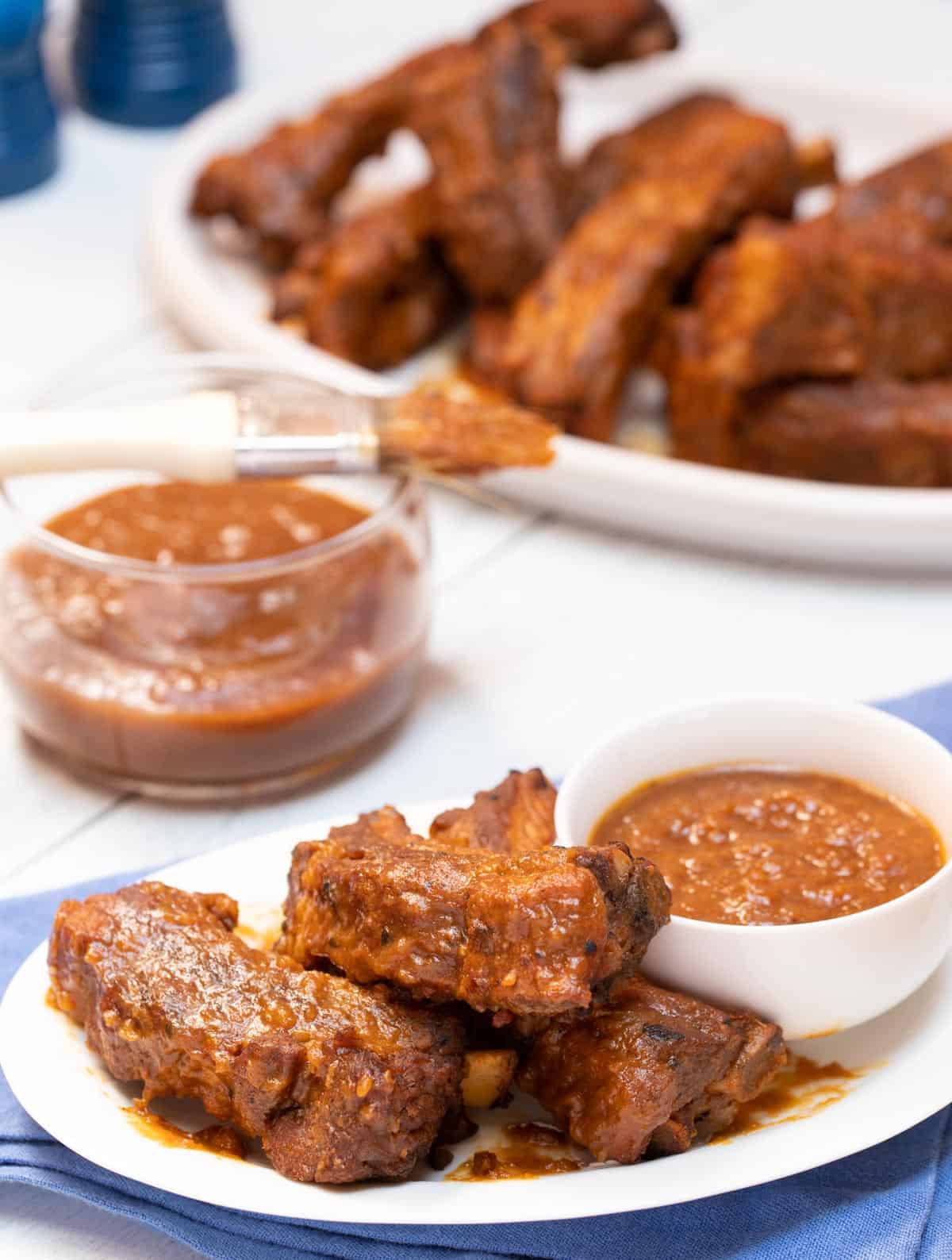 White dishes with Braised Baby Back Ribs with Zesty BBQ Sauce