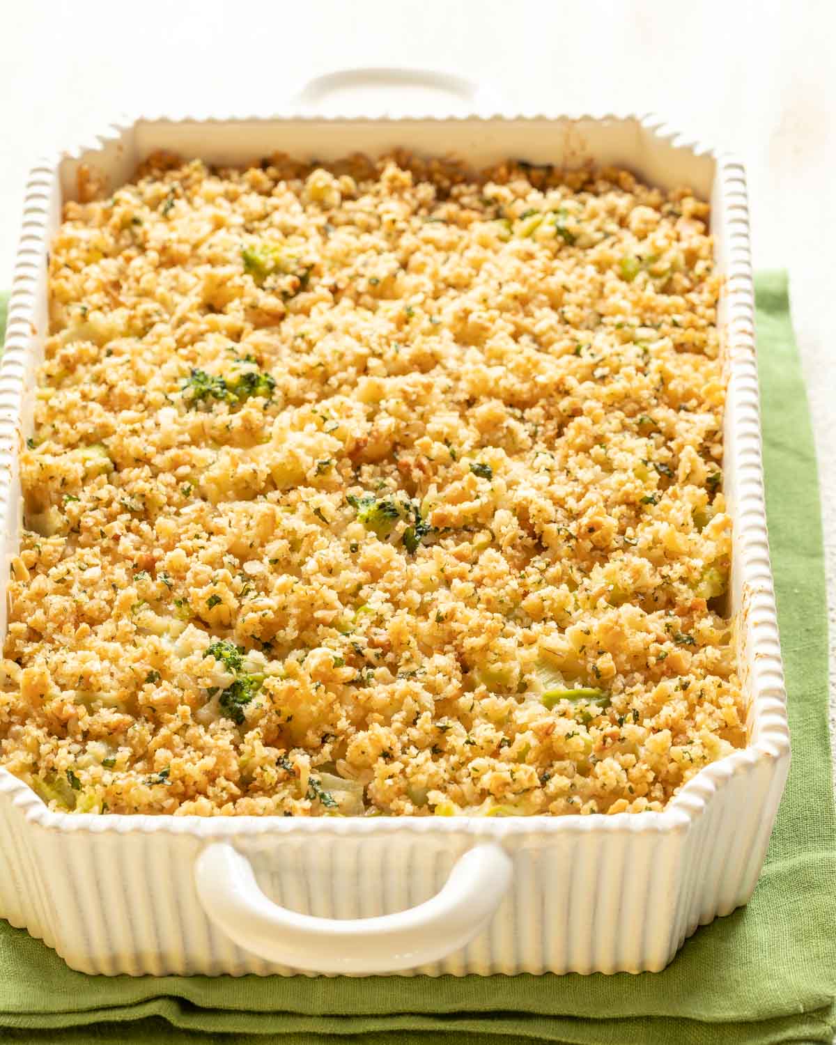 White casserole dish holding Cheesy Broccoli Rice Casserole