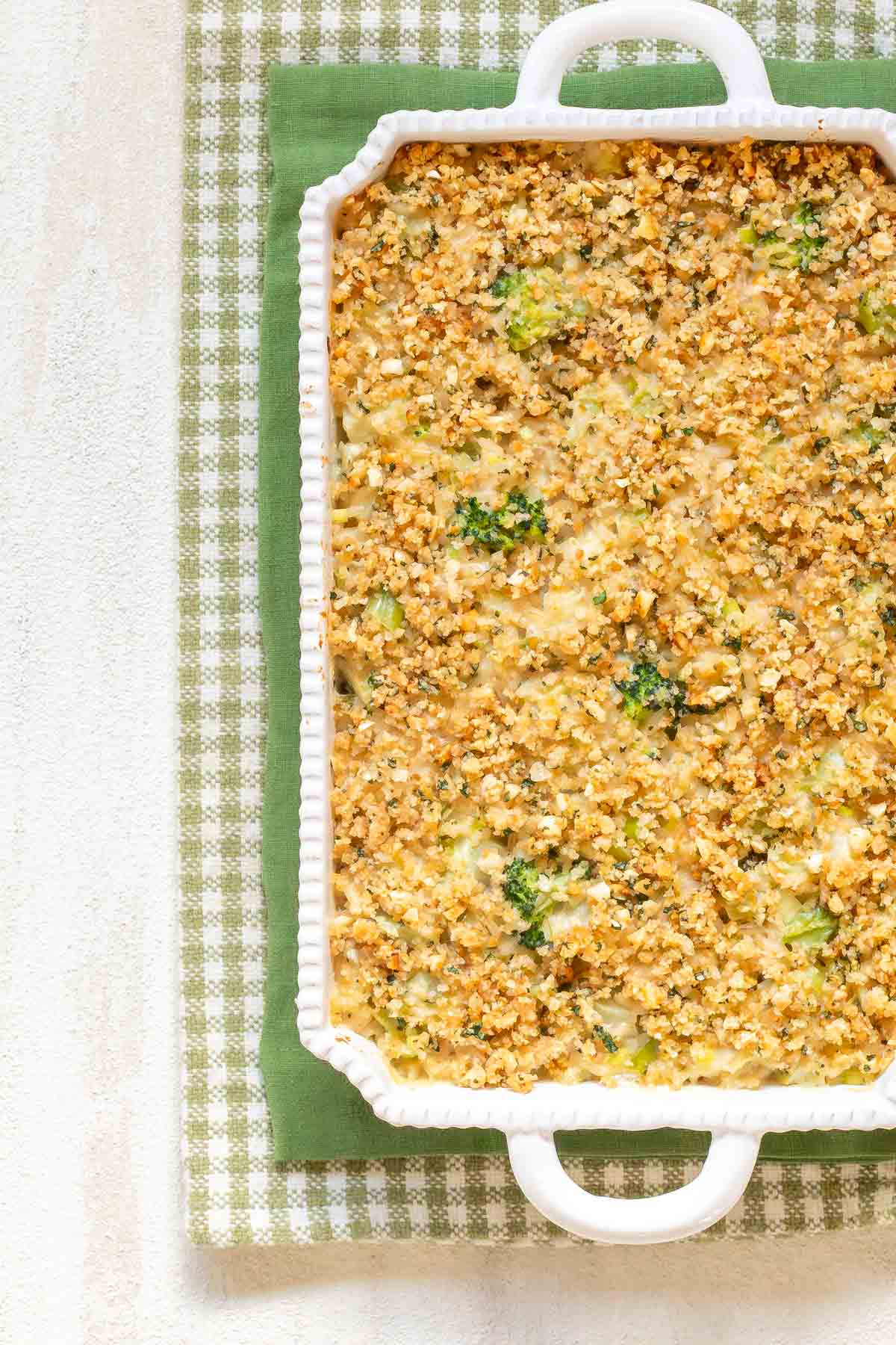 Overhead view of a white cassserole dish with handles holding Cheesy Broccoli Rice Casserole