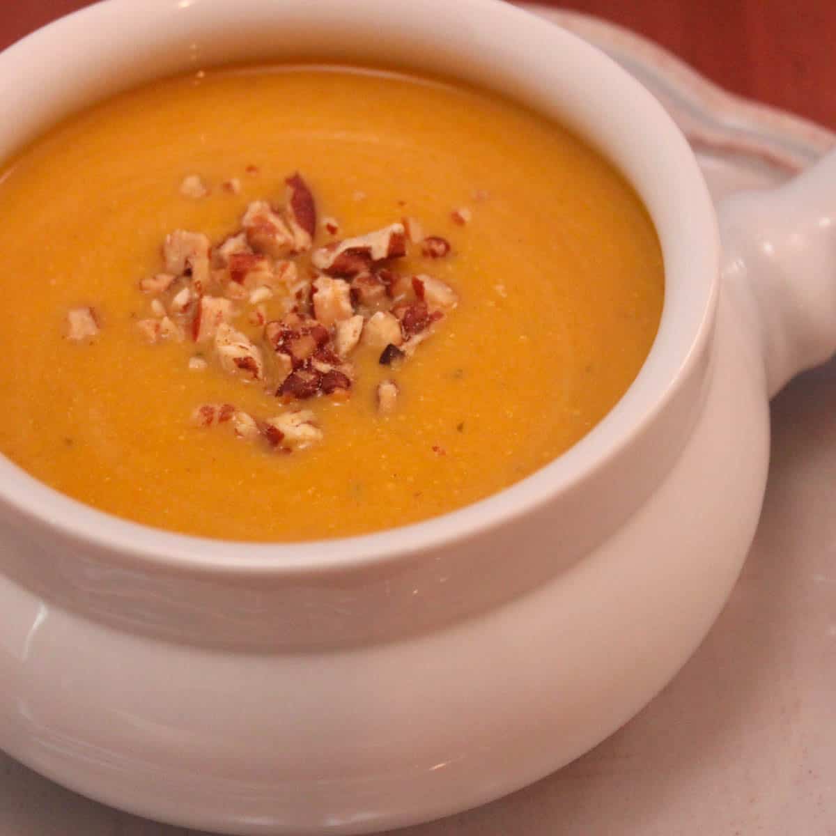 White soup bowl filled with Butternut Squash Soup