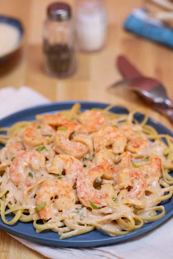 Blue plate filled with Cajun Shrimp Linguine