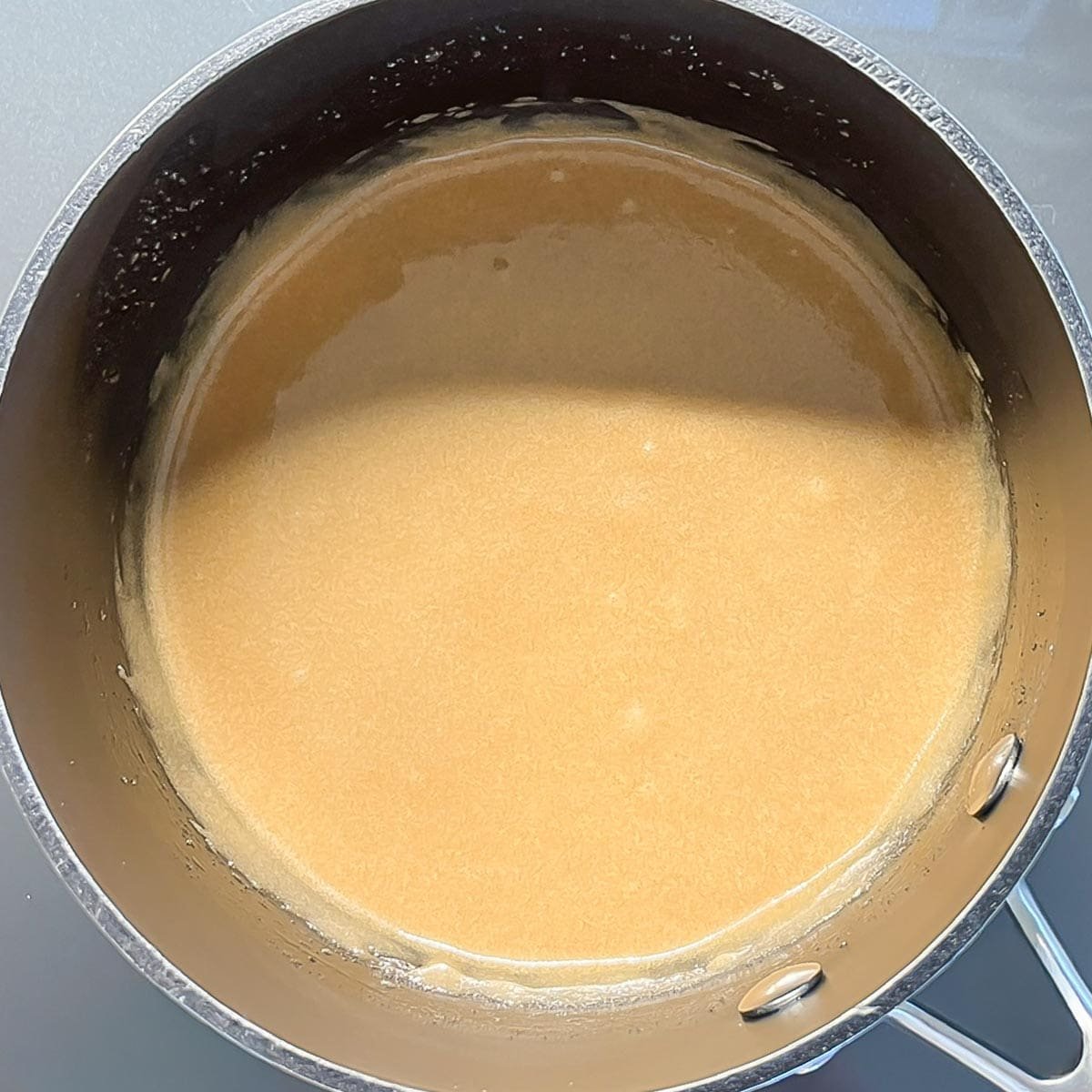 butter and brown sugar for Caramel Frosting combined in a saucepan after cooking