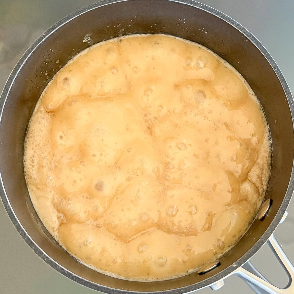 saucepan with frosting mixture at a low boil