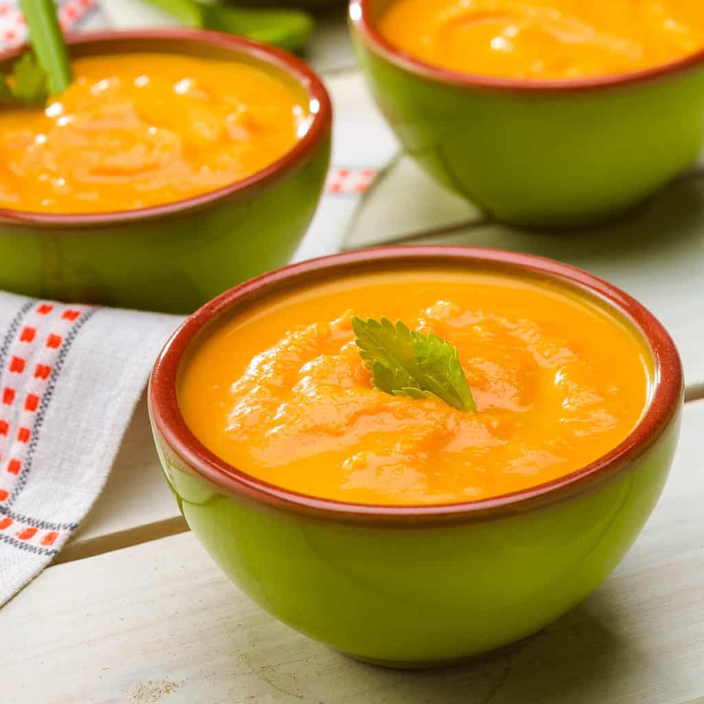 three bowls showing servings of Creamy Carrot Ginger Soup
