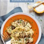 Orange plate with slices of grilled Cauliflower with Parmesan Cheese Sauce
