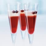 Three champagne flutes filled with Champagne Cocktail