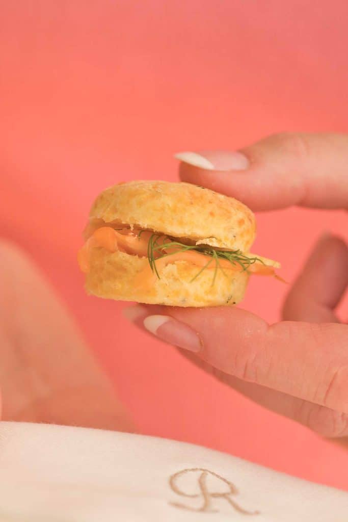 hand holding one Mini Cheddar Dill Scone; photo illustrates size of scone