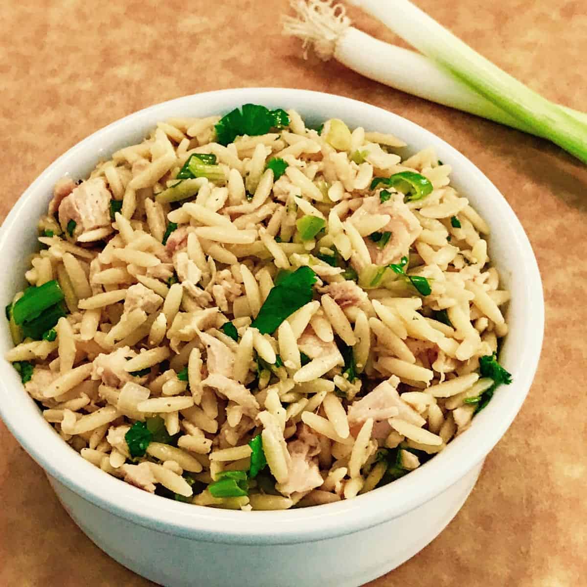 White bowl filled with Chicken and Orzo Salad with Peanut Dressing