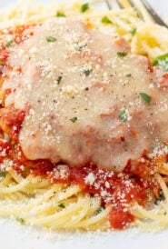 Perfectly cooked pasta served with chicken parmesan, showing tender al dente texture and lightly coated noodles.