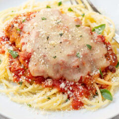 Perfectly cooked pasta served with chicken parmesan, showing tender al dente texture and lightly coated noodles.