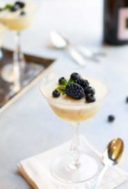 Champagne coupe glasses filled with Chilled Lemon Souffles, topped with blackberries and blueberries