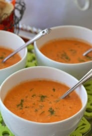 Individual white bowls of Chilled Tomato Dill Soup