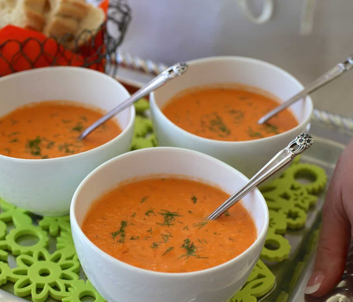 Individual white bowls of Chilled Tomato Dill Soup