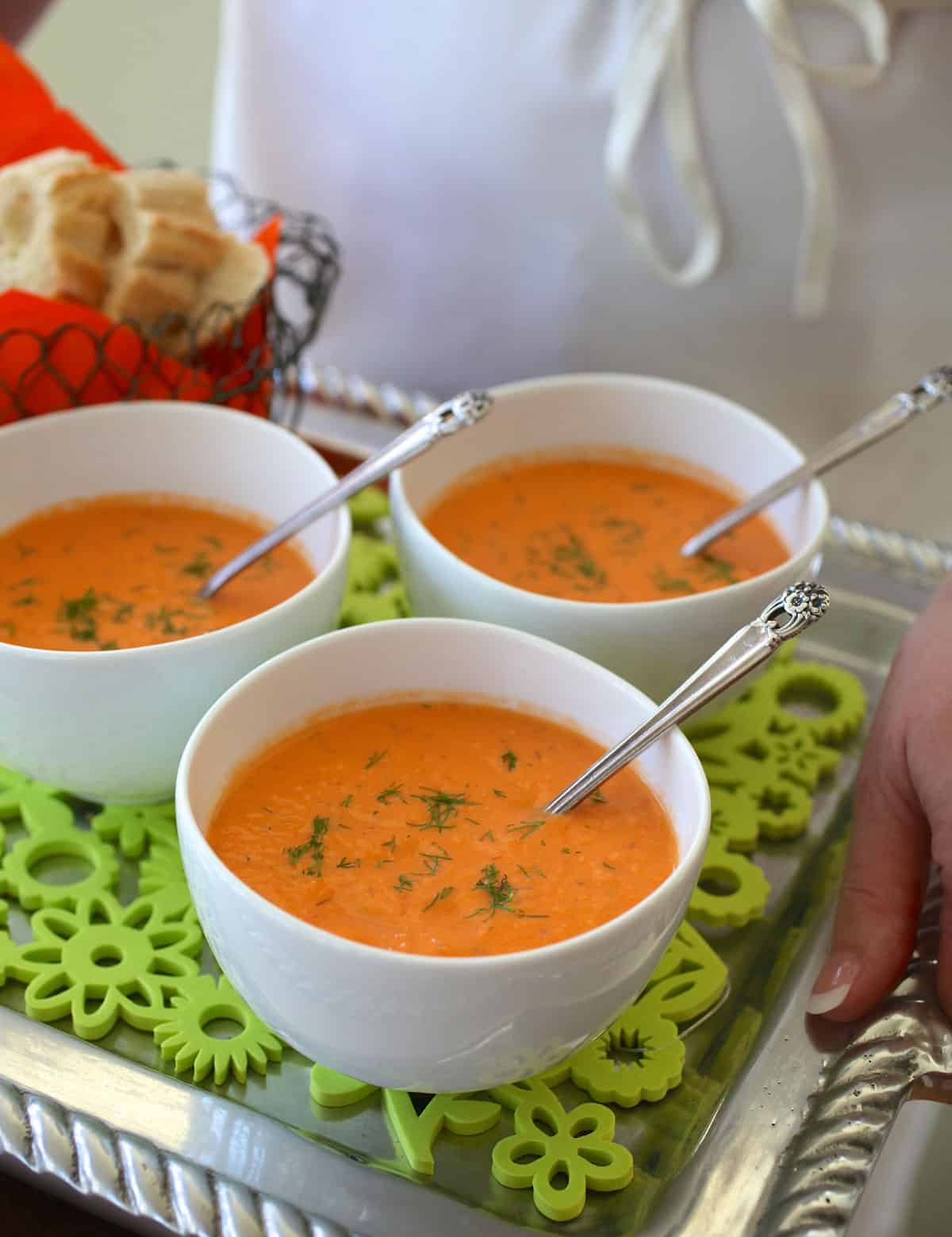 Three white bowls filled with Chilled Tomato Dill Soup