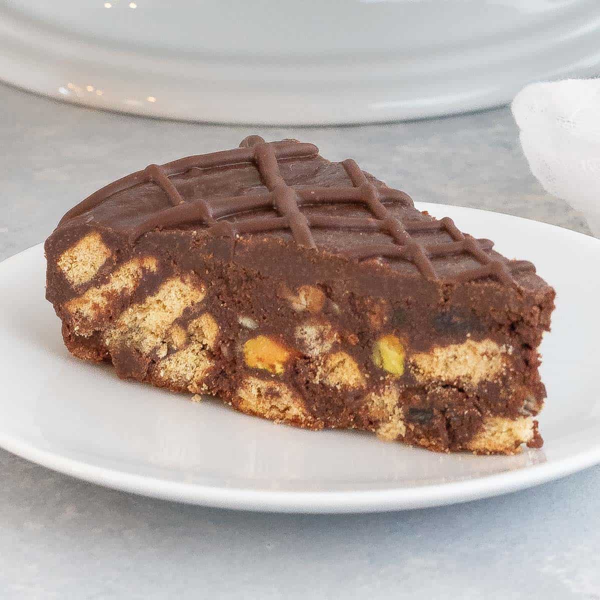 SIngle serving of chocolate biscuit cake on a white plate.