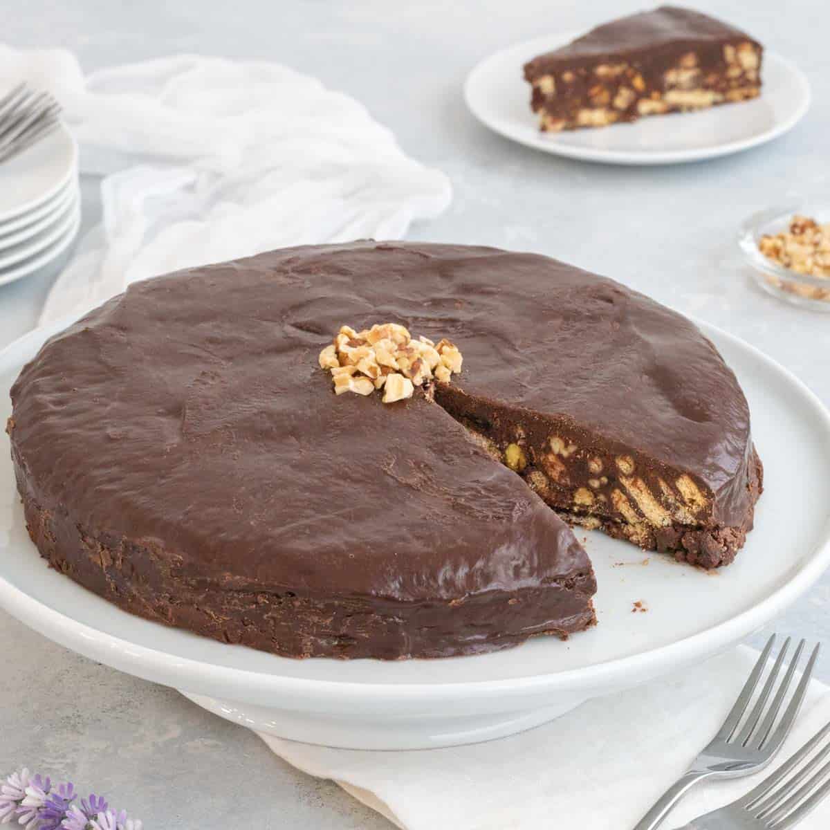 Chocolate biscuit cake with a slice removed to show the cake's inside.