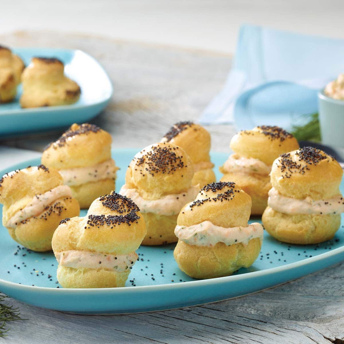 Choux pastry baked into poppy seed puffs and filled with smoked salmon spread