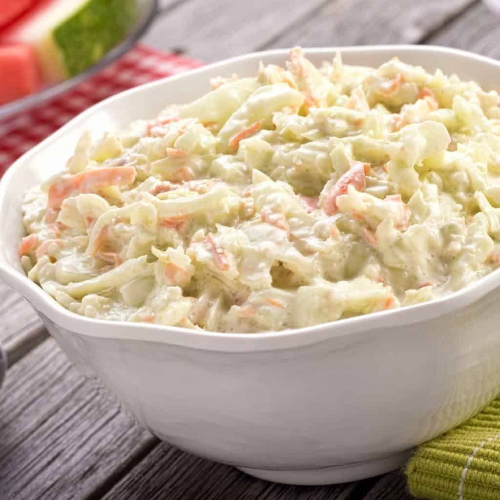 white bowl filled wit Coleslaw wit Lemon Mayo Dresisng