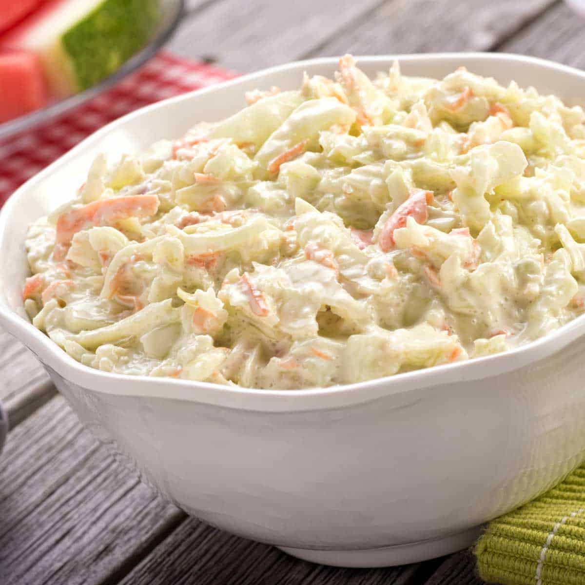white bowl showing a portion of Coleslaw with Lemon Mayonnaise Dresisng