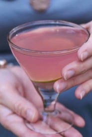 hands holding a Cosmopolitan Martini