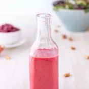 Narrow necked bottle filled with Cranberry Vinaigrette.