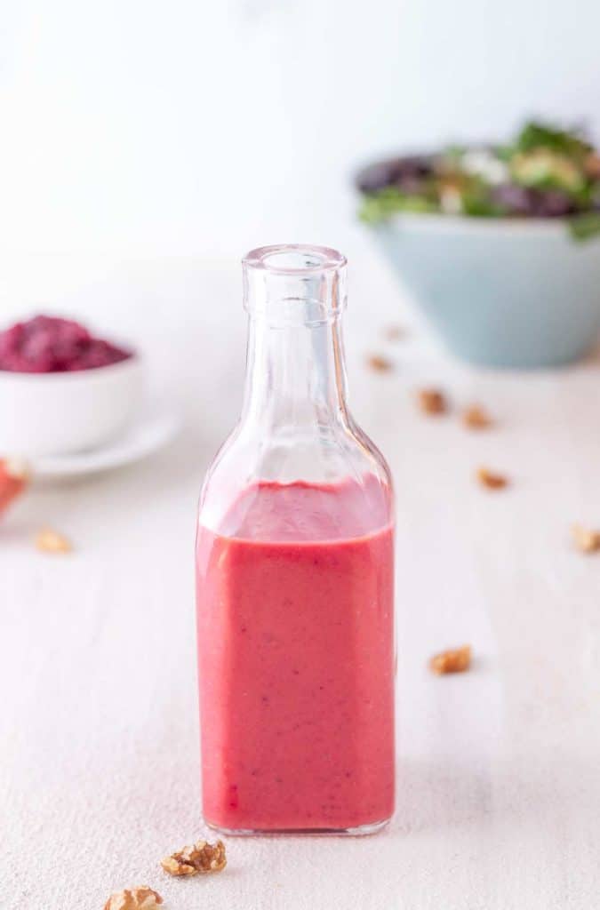 Narrow necked bottle filled with Cranberry Vinaigrette. 