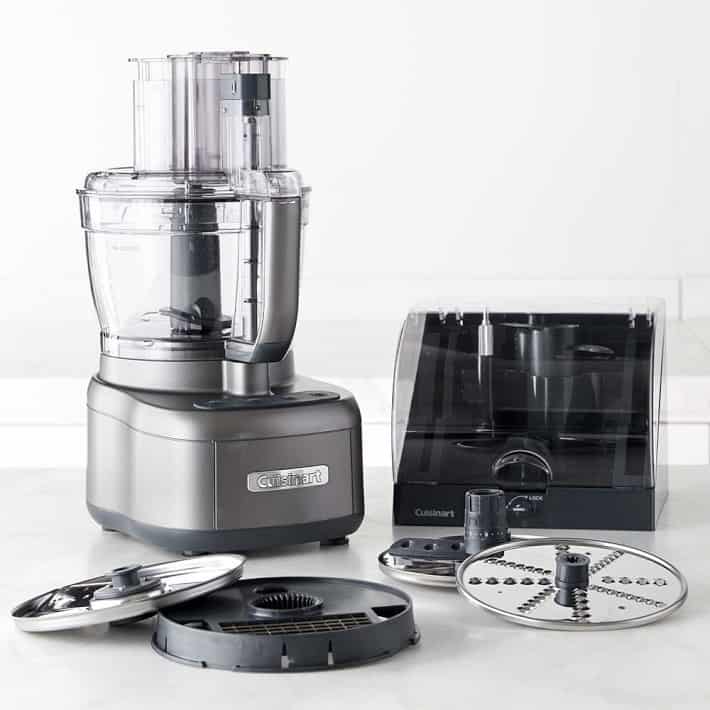 Cuisinart showing various dicing, slicing and grating blades as well as storage container