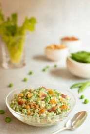 Glass bowl filled with Curried Pea Salad with Bacon and Cashews