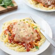 Breaded chicken breast covered with marinara sauce and melted cheese, atop cooked spaghetti