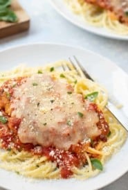 Breaded chicken breast covered with marinara sauce and melted cheese, atop cooked spaghetti