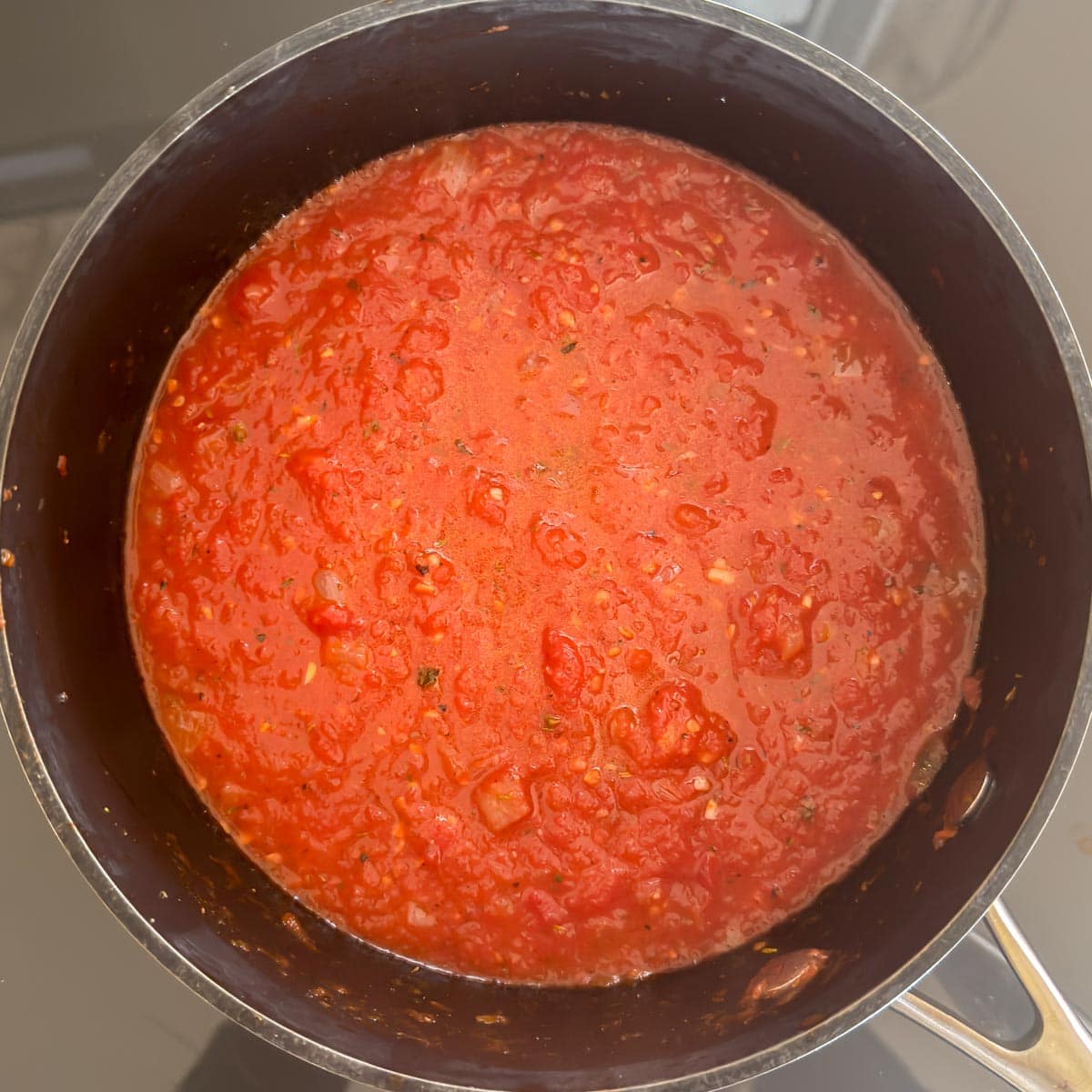 Marinara sauce in a saucepan showing texture after blending.