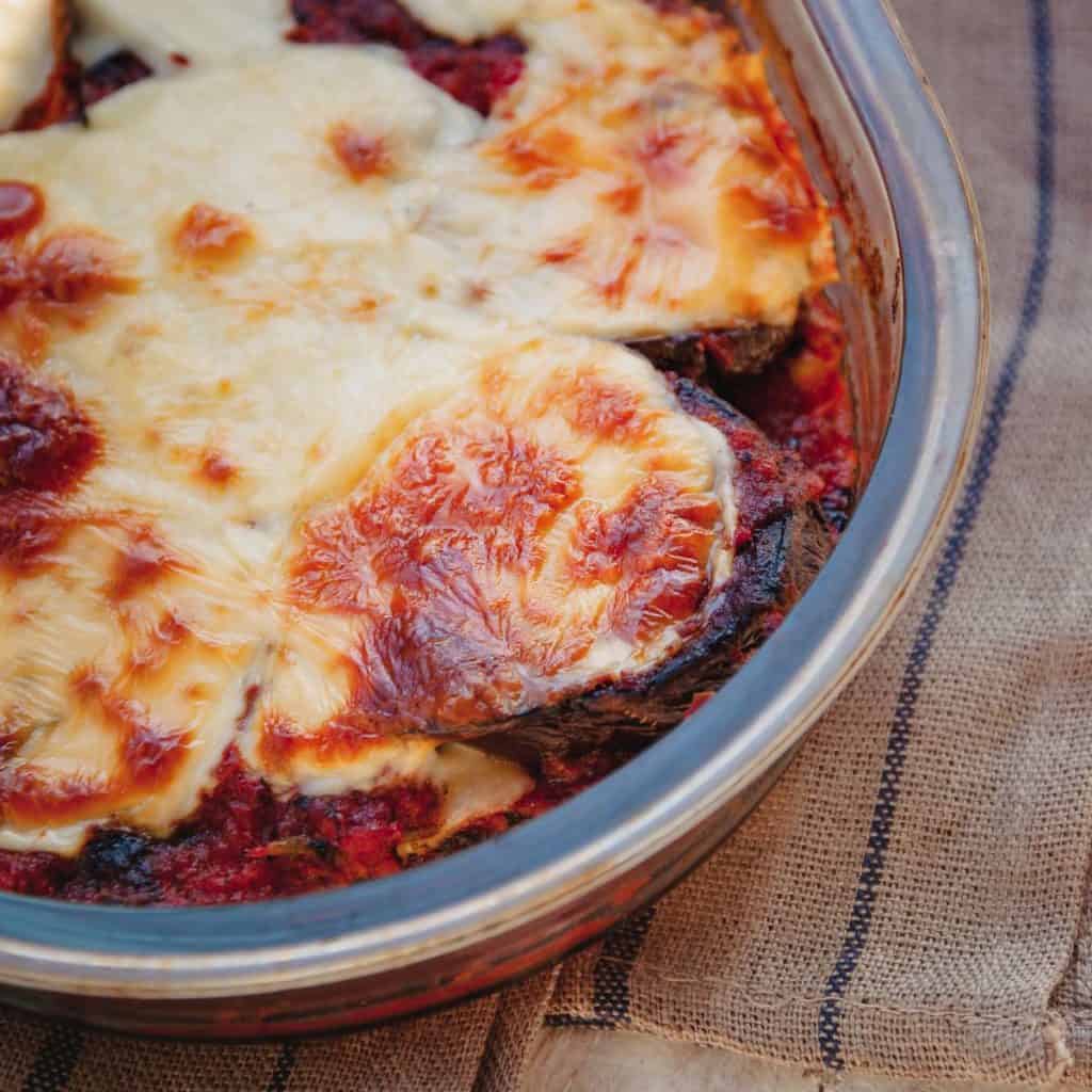 Baking dish with Eggplant Parmesan with Sausage, Mushroom and Olive Marinara Sauce