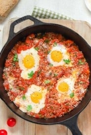 Overhead of cast iron skillet holding Poached Eggs in Italian Tomato Sauce