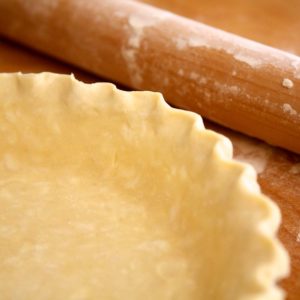 shot of an unbaked Flaky Pie Crust with a rolling pin