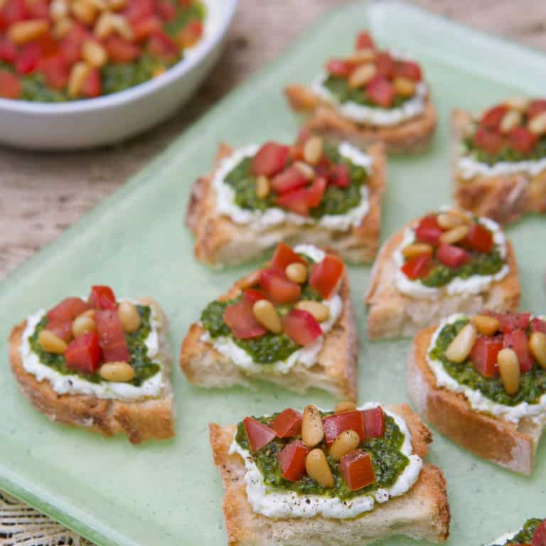 platter holding two bite Tomato, Pesto and Goat Cheese Crostini